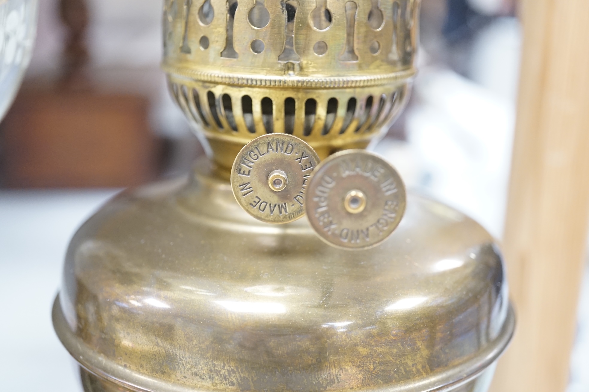 A late 19th century brass oil lamp with painted bowl and opaque shade together with a later oil lamp, largest 59cm high. Condition - fair to good